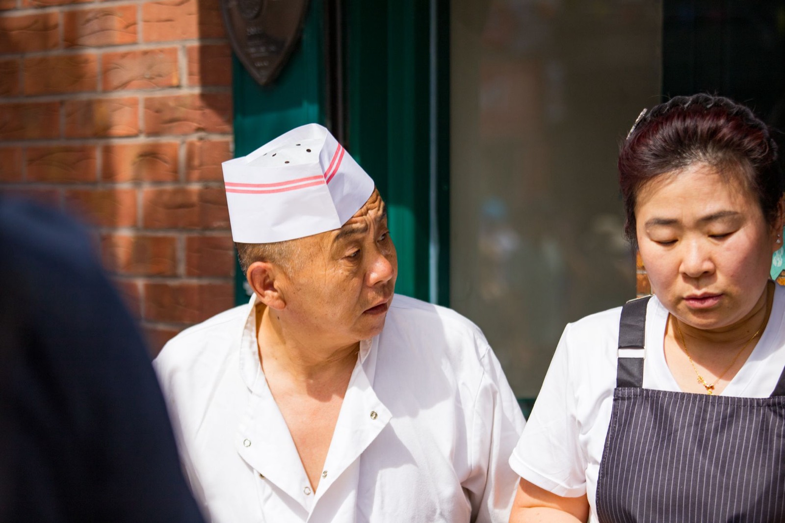 Two chefs talking through the handover between shifts