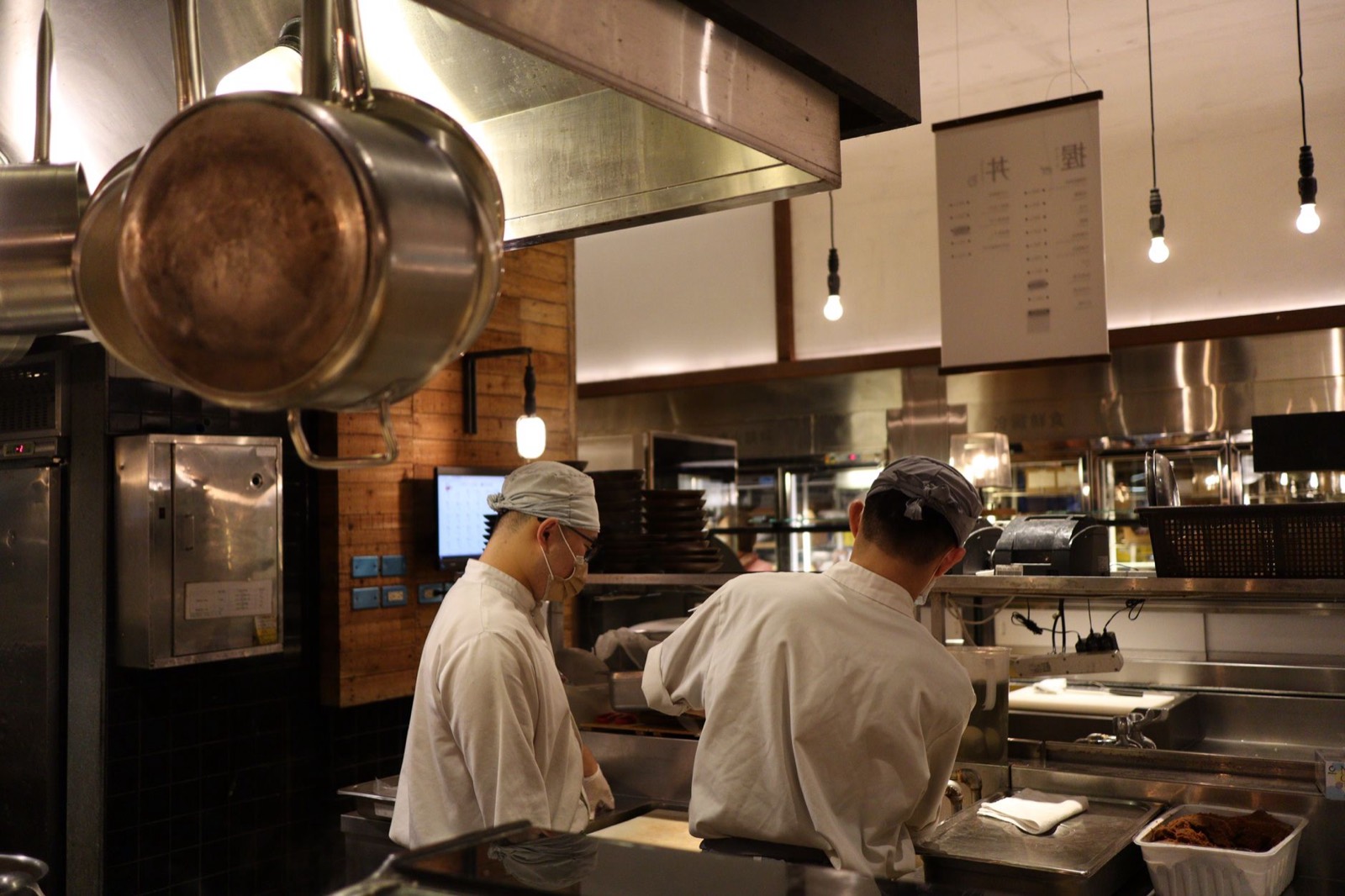 Chefs working a busy service in a restaurant kitchen